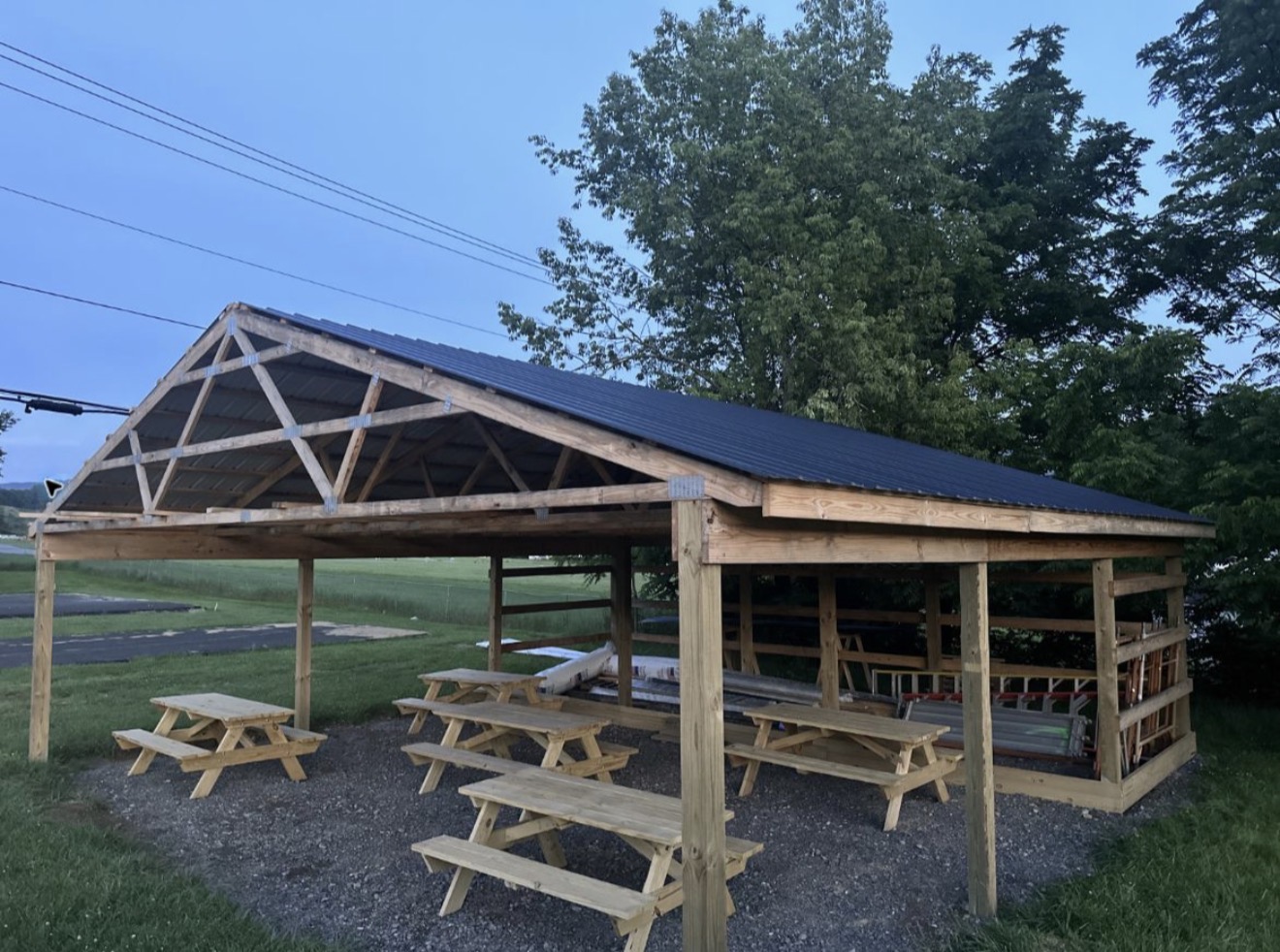 Warhawk Park pavilion under construction with picnic tables and building materials